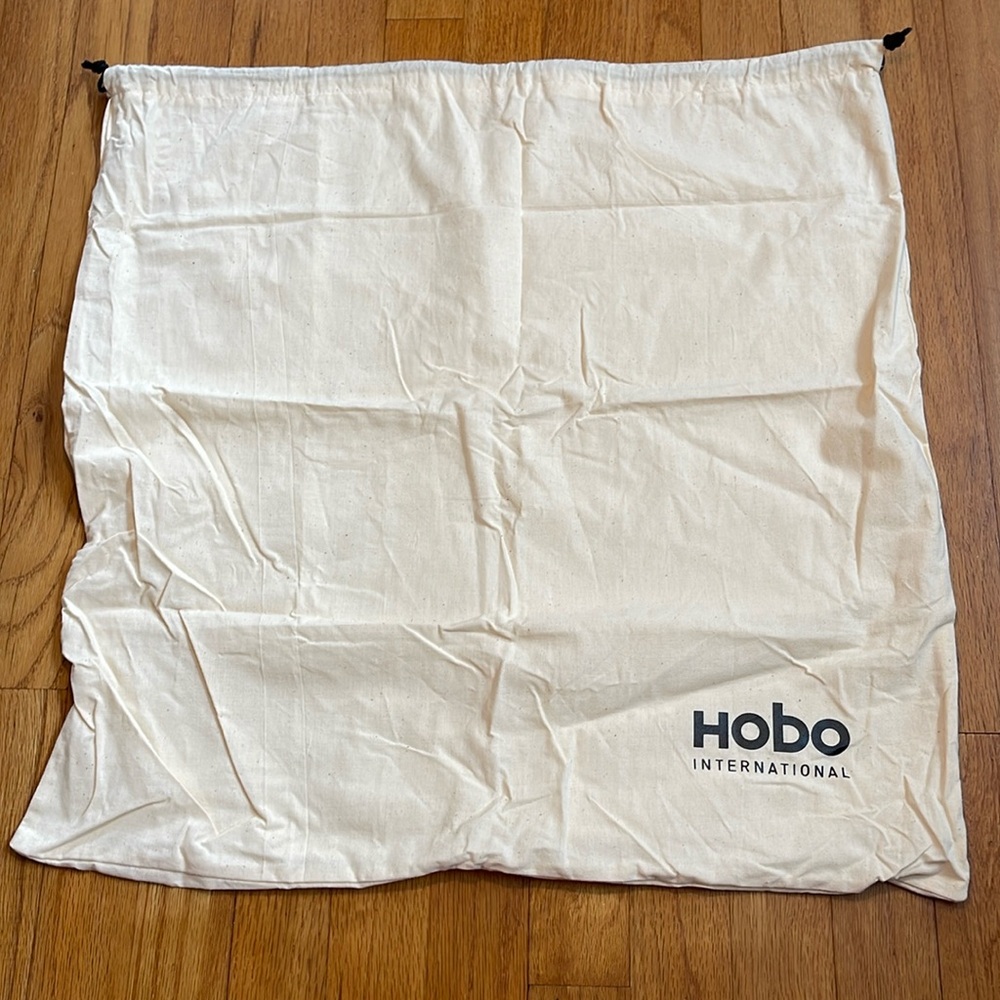 HOBO International. 21.5”x22”. Dust bag. Cream with black